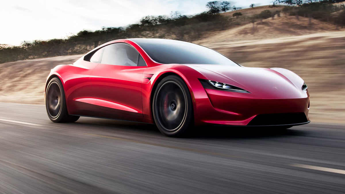 Tesla's next-generation Roadster prototype in red, shown low and wide on display