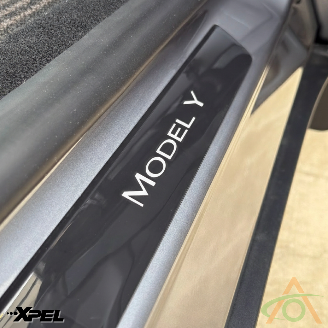 Xpel matte PPF sill protector with white wordmark decal for Model Y