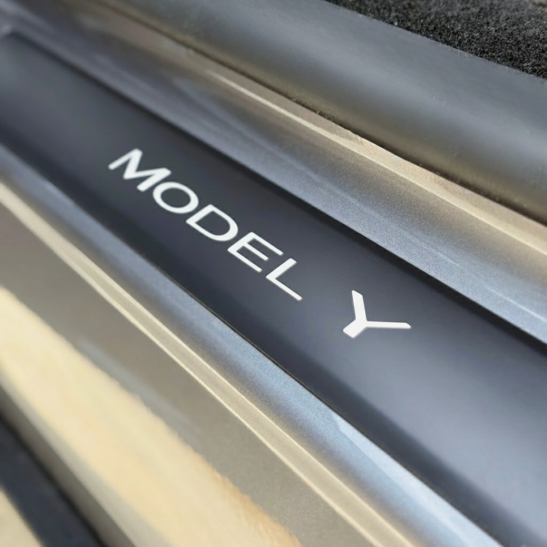 Xpel matte PPF sill protector with white wordmark decal for Model Y